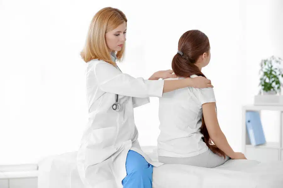 doctor_female_examine_girls_spine_shoulders_104657557_l_photo-source-123rf-com_-2