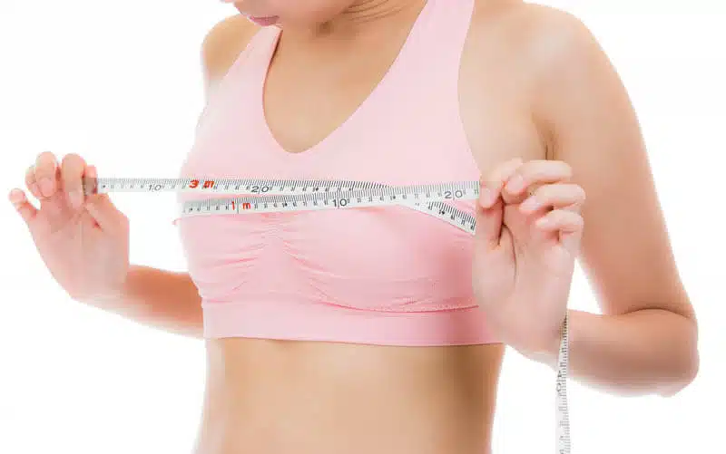 woman with small breasts tape measure AdobeStock 101107381