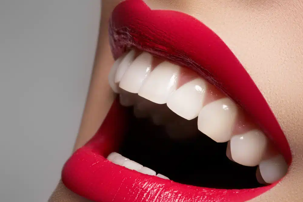 close-up-happy-female-smile-with-healthy-white-teeth-bright-magenta-lips