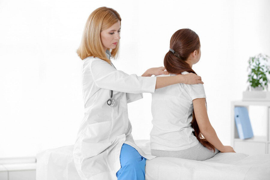doctor_female_examine_girls_spine_shoulders_104657557_l_photo-source-123rf-com_